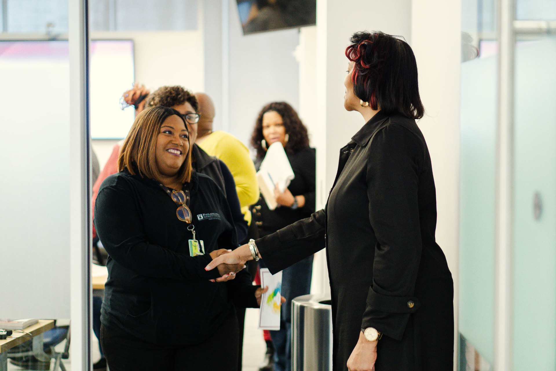 Janice Coleman greeting and speaking personally with an attendee at an event